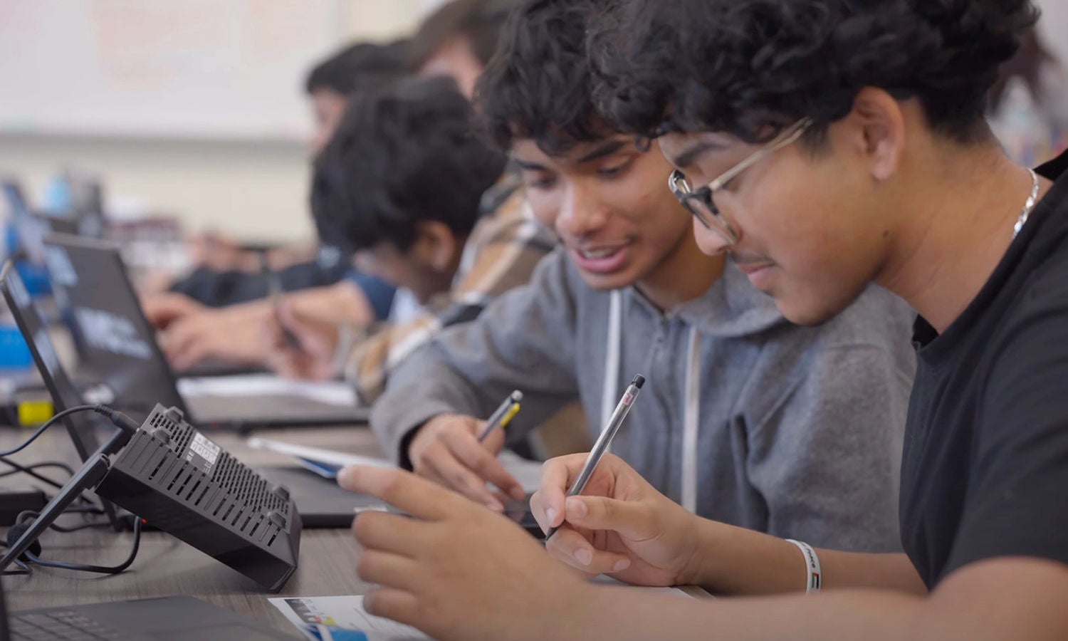 A group of students is working on writing assignments.